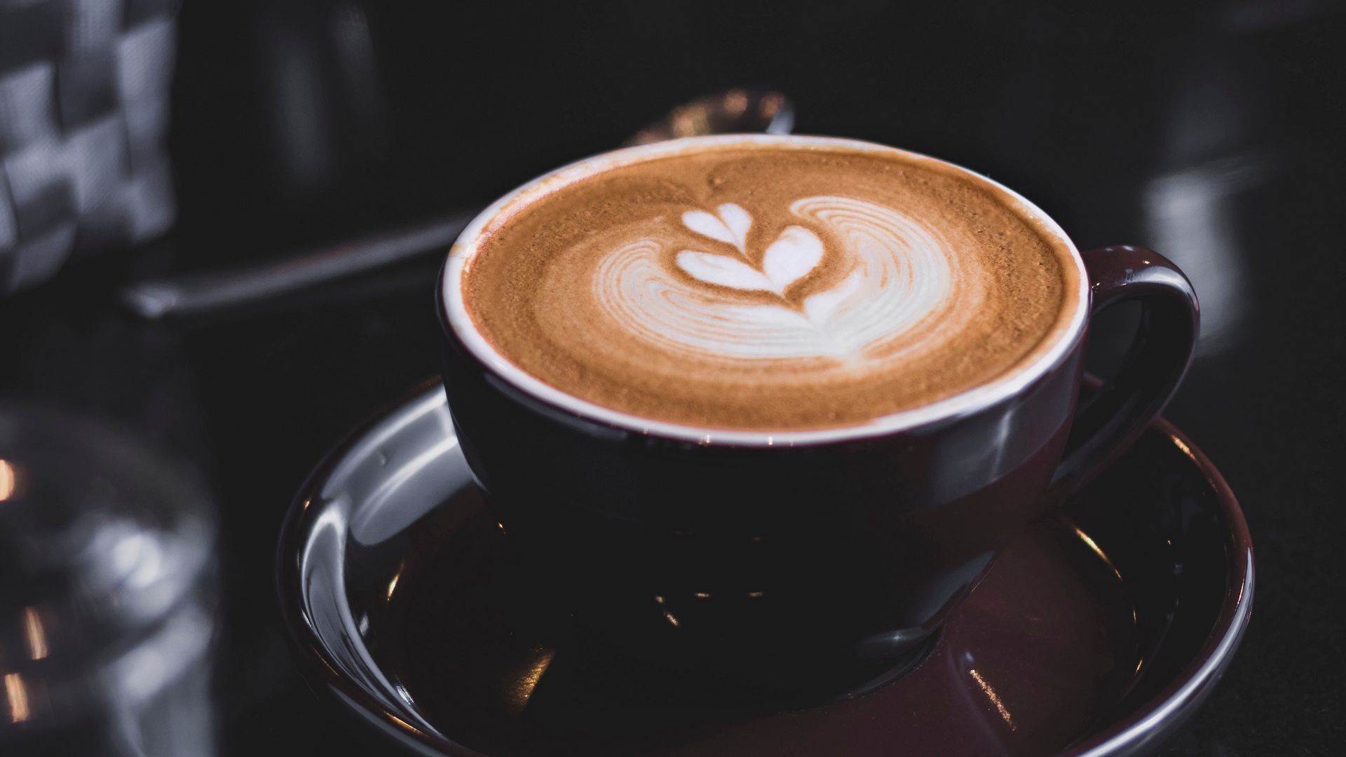 Cappuccino with latte art on a dark surface